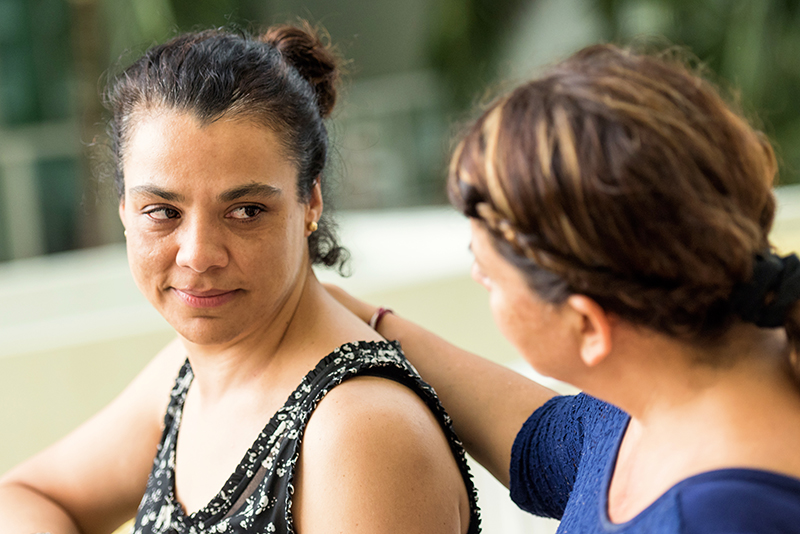 Sad woman being comforted by a friend