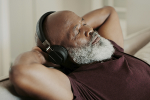man relaxing listing to headphones