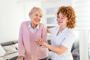 senior woman receiving assistance from caregiver
