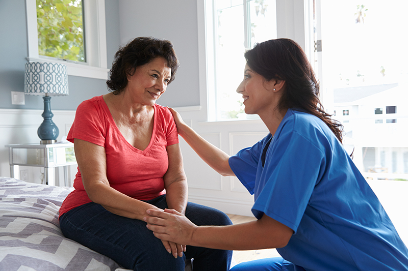 caregiver comforting senior woman