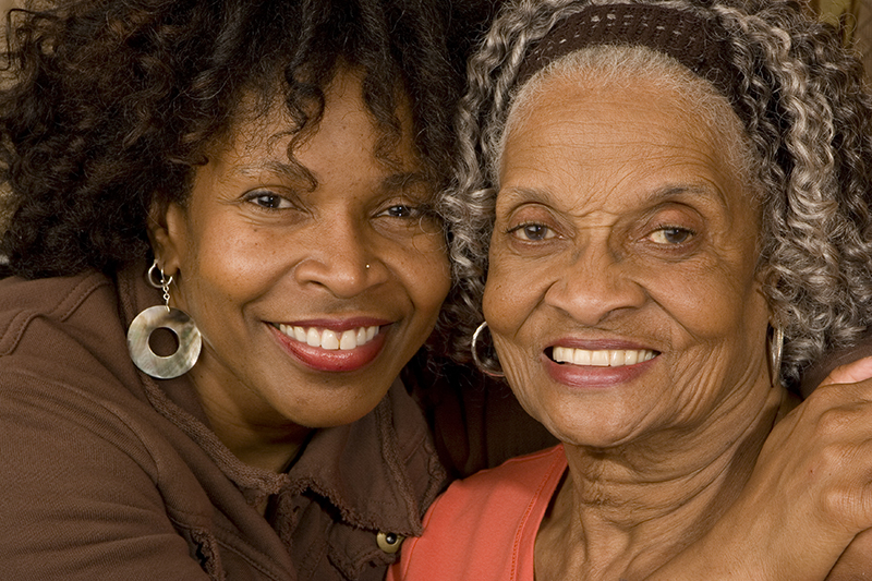 happy adult daughter with senior mother with dementia