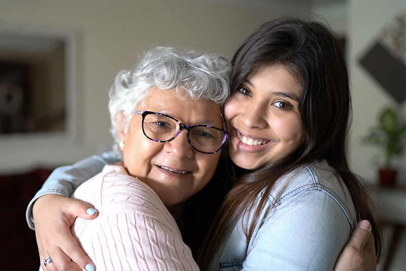 progression of dementia in senior hugging caregiver