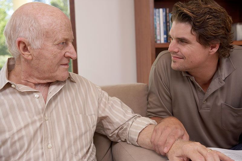 adult-son-talking-to-senior-father-with-dementia