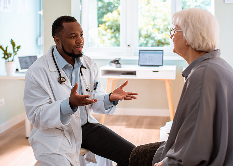 geriatrician doctor talking with senior