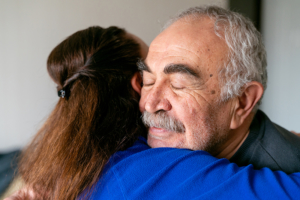 senior man hugging caregiver