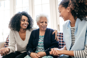 adult daughter and senior mother talking to caregiver