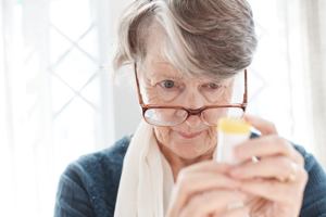 Senior woman reading a prescription bottle