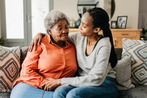 A woman considering 24-hour Alzheimer’s care embraces her mother.