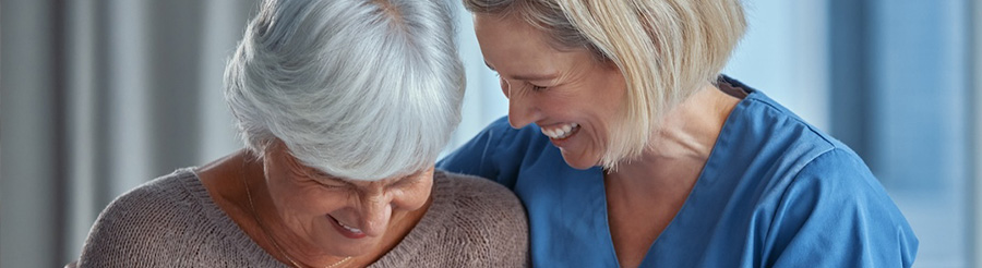 A caregiver in the Fort Lauderdale area shares a laugh with an older woman