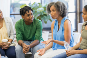 A woman utilizing effective family communication tips speaks to her siblings about the care of their aging parents.