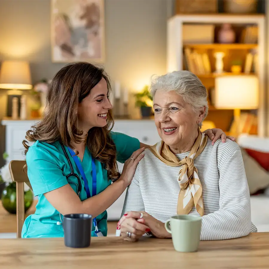 Caregiver sitting at the kitchen table with client